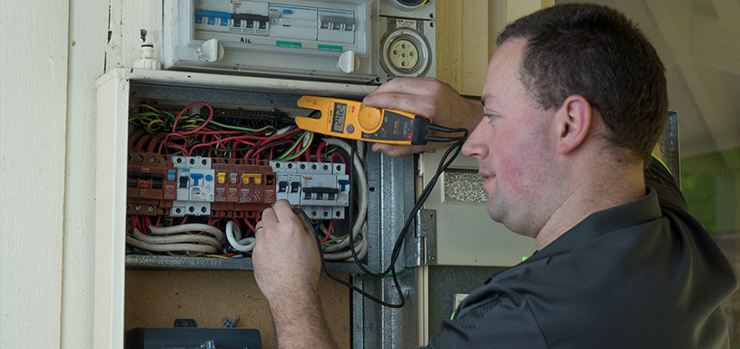 Technician looking at switch board
